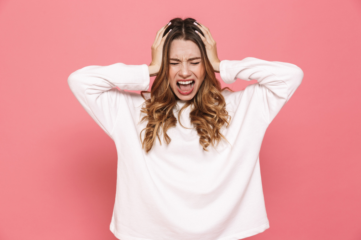 Portrait of an Irritated Young Casual Girl Screaming